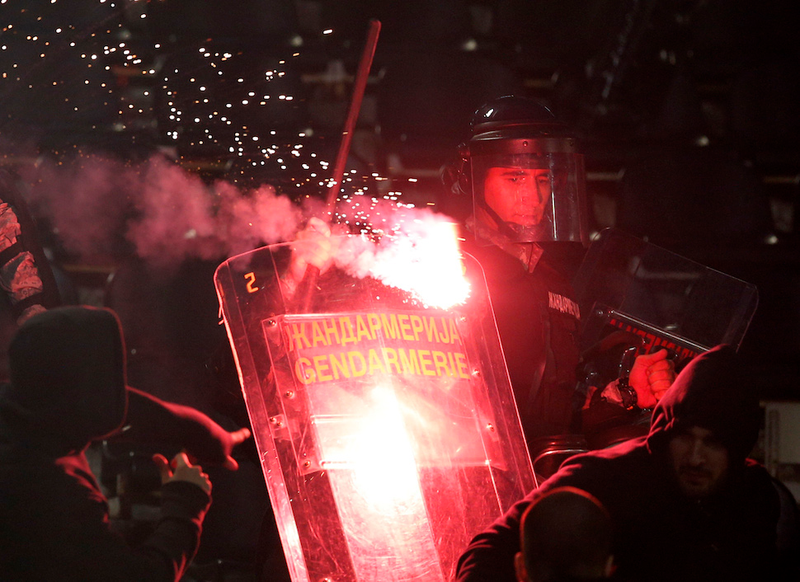 Illustration for article titled Smoke, Flares, Riot Police In Belgrade Derby Make For Haunting Photos